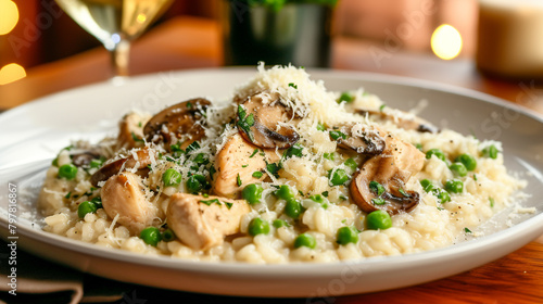 A plate of risotto with chicken, mushrooms, and peas, cooked with white wine and butter, sprinkled with parmesan cheese.