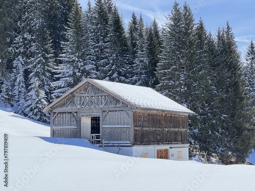 Old traditional swiss rural architecture and alpine livestock farms in the winter ambience of the tourist resorts of Valbella and Lenzerheide in the Swiss Alps - Canton of Grisons, Switzerland © Mario