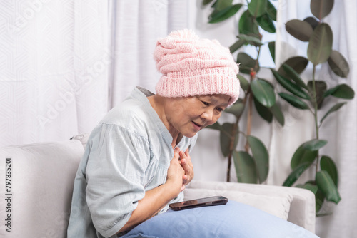 Stressed senior woman with breast cancer have trouble with chemotherapy healing, elderly retirement female pain and difficulty breathing according to chemotherapy or heart attacks stay at home alone