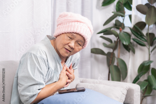 Stressed senior woman with breast cancer have trouble with chemotherapy healing, elderly retirement female pain and difficulty breathing according to chemotherapy or heart attacks stay at home alone