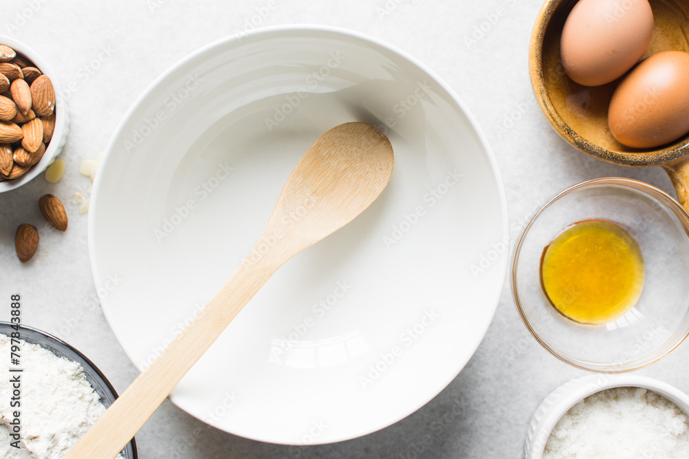 overhead view of ceramic bowl with a wooden spatula on a marble table, white ceramic mixing bowl overhead view of ceramic bowl with a wooden spatula on a marble table, white ceramic mixing bowl