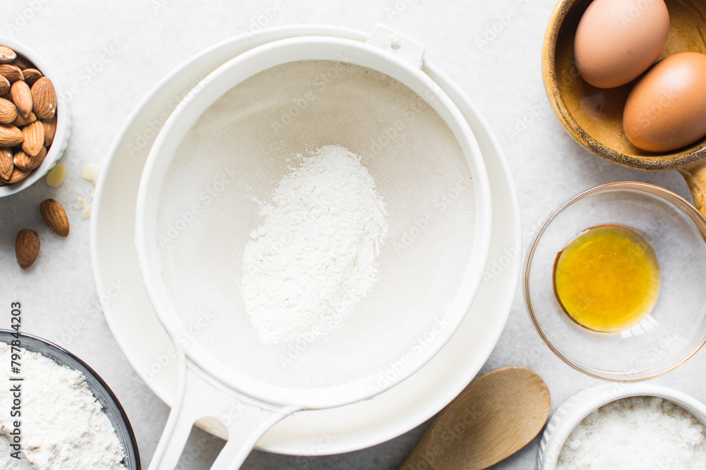 Sifting flour for baking, a plastic sieve with flour in it Sifting flour for baking, a plastic sieve with flour in it
