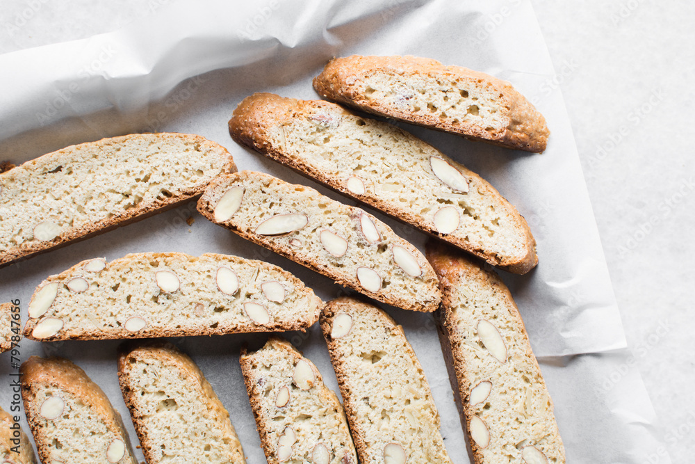 almond biscotti on white marble countertop, almond cantucci cookies on a white board, flatlay of slices of biscotti cookies or twice baked cookies