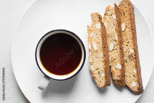 overhead view of coffee and almond biscotti on a white background, almond cantucci cookies on a white background, flatlay of coffee biscotti cookies or twice baked cookies