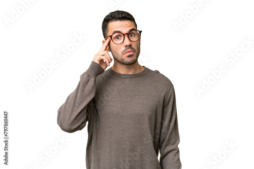 Young handsome caucasian man over isolated background thinking an idea