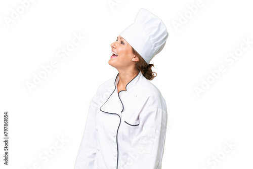 Middle-aged chef woman over isolated background laughing in lateral position photo