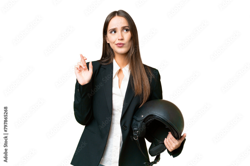 Young Asian woman with a motorcycle helmet over isolated chroma key background with fingers crossing and wishing the best Young Asian woman with a motorcycle helmet over isolated chroma key background with fingers crossing and wishing the best