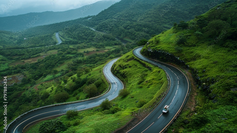 A group of friends enjoying a road trip through winding mountain roads, surrounded by lush greenery and stunning vistas.