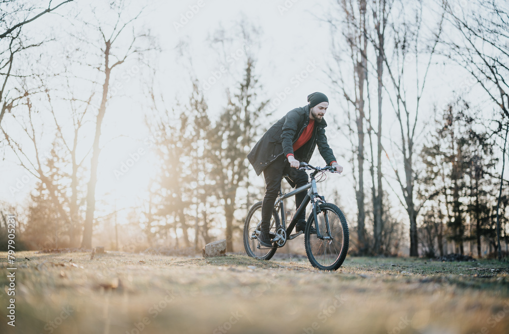A cheerful man enjoys a leisurely bicycle ride in a scenic park, surrounded by nature and bathed in the warm afternoon sunlight. A cheerful man enjoys a leisurely bicycle ride in a scenic park, surrounded by nature and bathed in the warm afternoon sunlight.