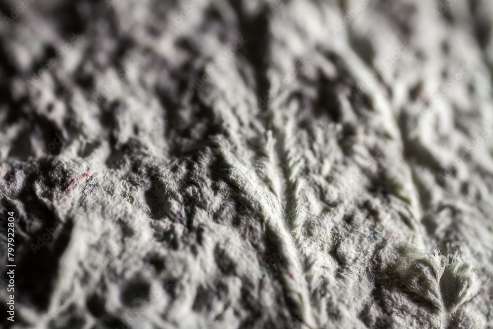 Extreme close up of old gray handmade paper mache with a structure and rough texture. Extreme close up of old gray handmade paper mache with a structure and rough texture.