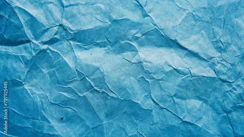 Textured blue surface with a pattern reminiscent of cracked ice or dry earth.