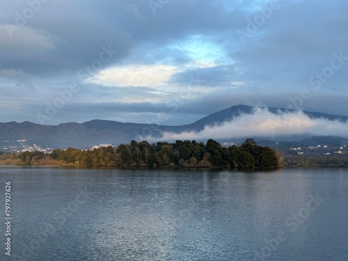Cloud laying on a mountain near the river Minho near Eiras, O Rosal, Galicia, Spain, March 2023 photo