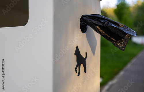 Obraz na płótnie Dog waste bags in a park. Close up photo of a garbage with plastic disposable bags for dog poop while walking them outside. w salonie