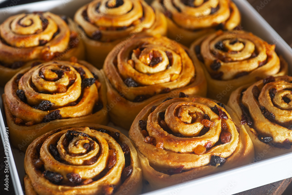 close up Freshly baked mixed fruit cinnamon rolls in a baking tray