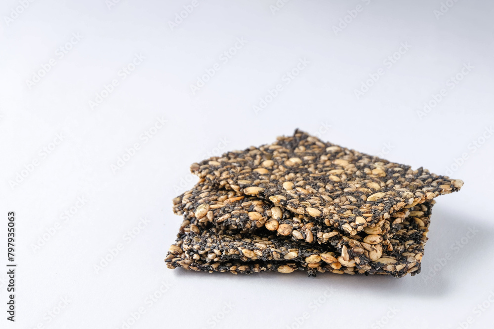 Homemade seed crackers on white background Homemade seed crackers on white background