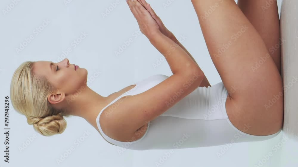 Young, fit and beautiful woman in white swimsuit posing over grey background. Vertical video. Healthcare, diet, sport and fitness. Young, fit and beautiful woman in white swimsuit posing over grey background. Vertical video. Healthcare, diet, sport and fitness.