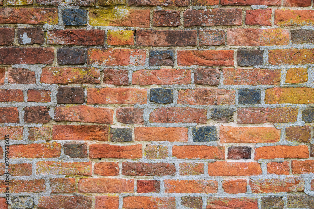 Obraz premium Fragment of a wall made of medieval antique handmade bricks. Background. Texture.