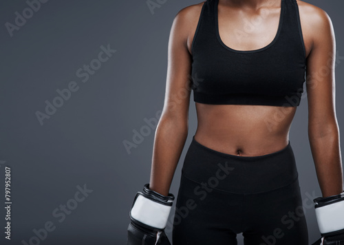 Boxing, fitness and woman with gloves in studio for workout, agility exercise and endurance. Person, sport and boxer with equipment for mma training, strength and resilience on grey background © peopleimages.com