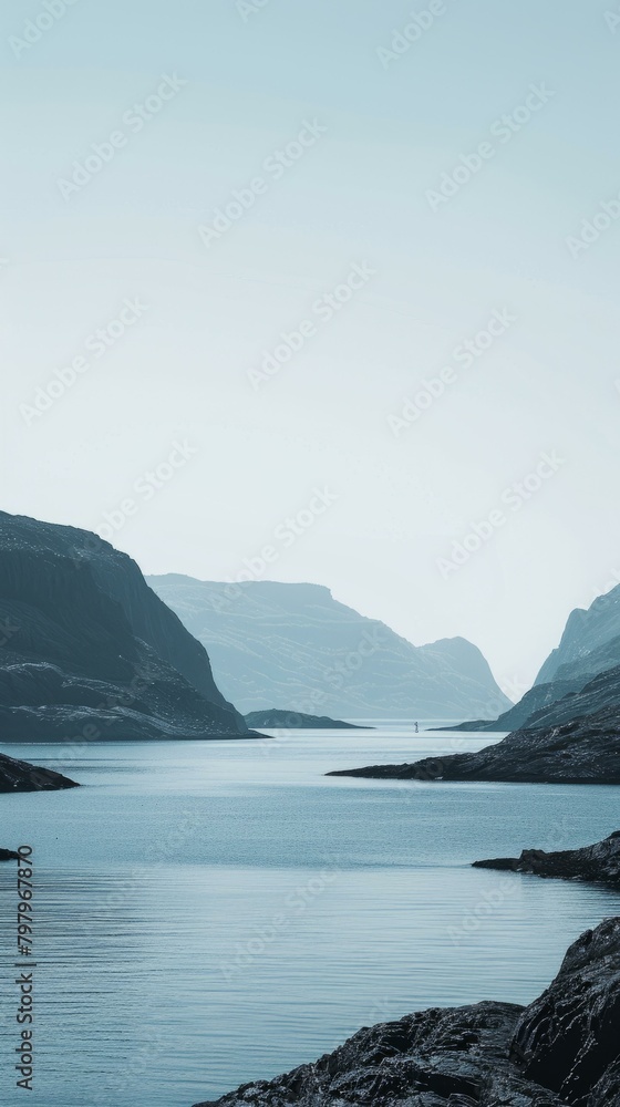 b'A boat sails through a narrow fjord between tall mountains'