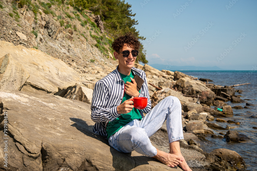 A young attractive guy is resting by the sea. A young attractive guy is resting by the sea.