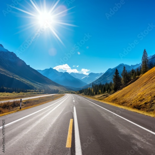 b'Road through the mountains with beautiful blue sky and bright sun' photo