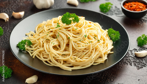 Close-up of spaghetti aglio e olio with sauteed garlic, chili flakes, parsley. Tasty Italian food.