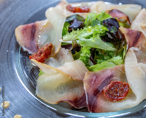 Swordfish carpaccio with salad and dried cherry tomatoes