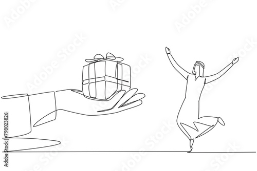 Single one line drawing young Arabian businessman excited to get the gift box from the giant hand. Surprise gift. Outstanding performance achievements. Continuous line design graphic illustration