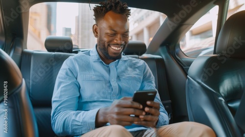 Smiling Man Using Smartphone in Car photo