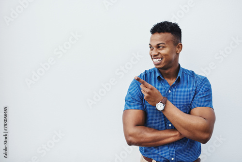 Business, mockup and African man with hand pointing to studio for news, announcement or recruitment info on white background. Contact us, presentation or entrepreneur show space for sign up promo
