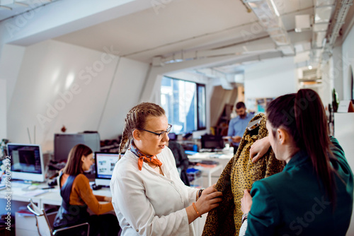 Two fashion designers working together on a project in a design studio