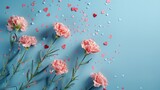 Mother's Day fashionable layout: Overhead shot of fresh carnations, sentimental message, tiny hearts, and confetti on a delicate blue surface, with blank space for words or adverts	