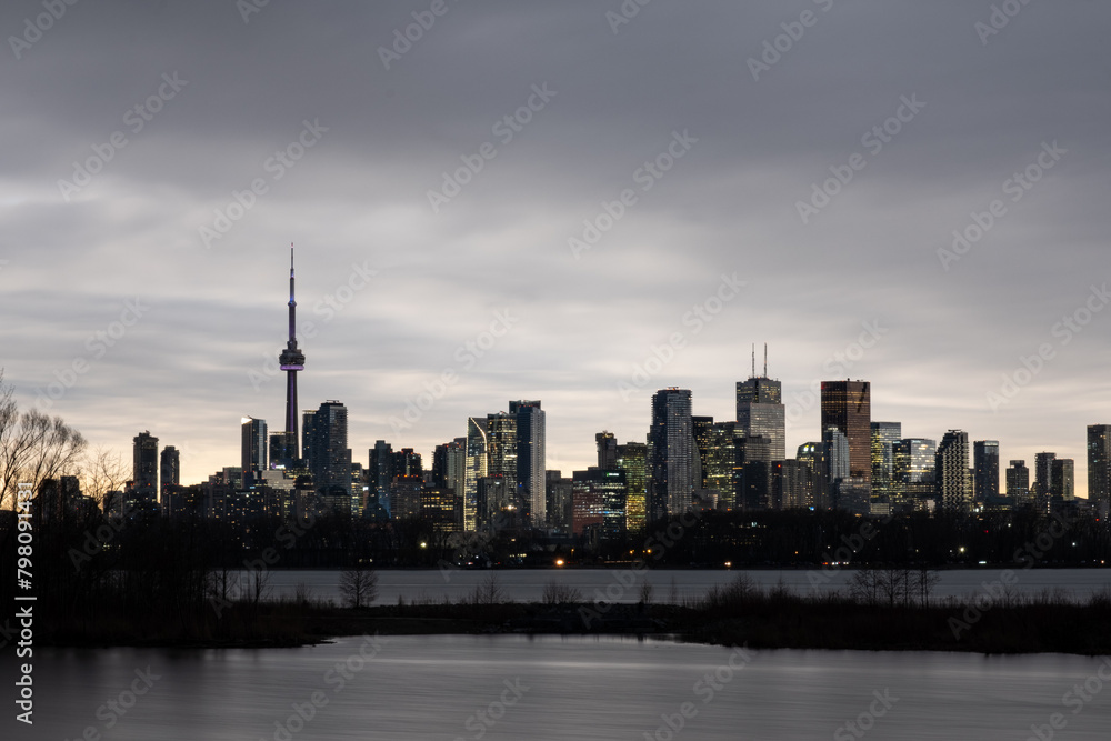 Toronto dark skyline at partial solar eclipse park view