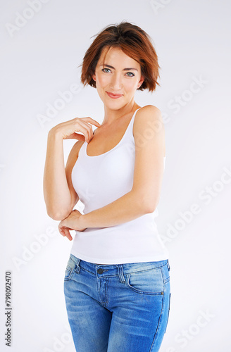 Portrait, smile and woman in studio for fashion, pride and happiness by white background. Millennial female person, confidence and informal for style, outfit and casual on backdrop for summer sale