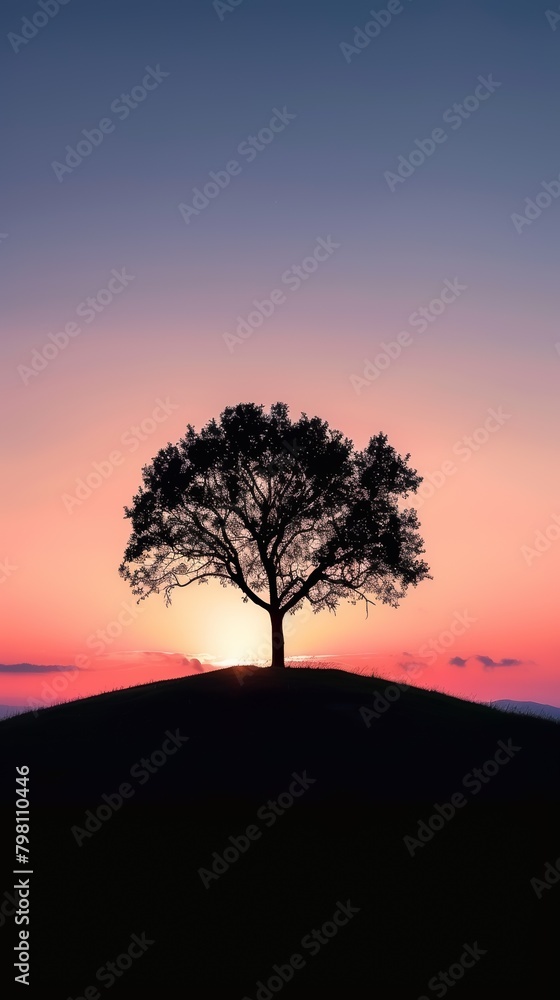 Dramatic silhouette of a single tree on a hill at sunset, peaceful and striking natural scene Dramatic silhouette of a single tree on a hill at sunset, peaceful and striking natural scene