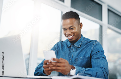 Smile, cellphone and black man by computer in office, workspace and desk happy in creative career. Communication, internship and journalist with tech for contact, research and internet for working © peopleimages.com