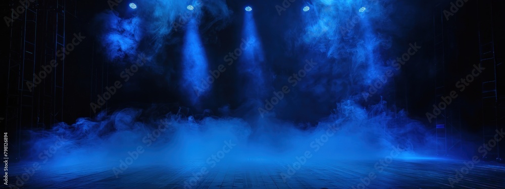 Black stage with blue smoke below, like fog on the floor. In a dark room.	
