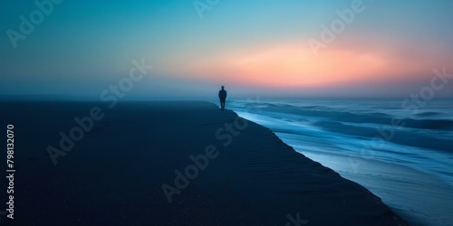 b'Man walking alone on beach at sunset'