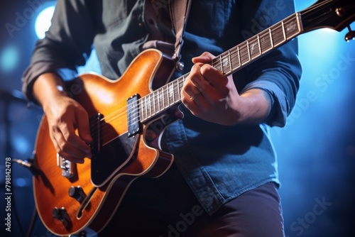 b'Close-up of a musician playing the guitar on stage' photo
