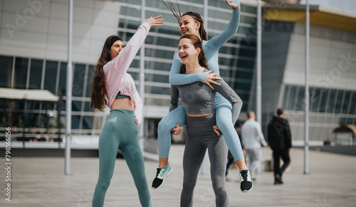 Two women in sportswear doing stretching exercises on a city street, preparing for a fitness session.