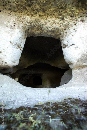  the ancient necropolis of 'Puttu Codinu' with the subterranean graves 'Domus de Janas' near the reservoir 'Lago di Temo' in the north west of Sardinia, Villanova Monteleone, Alghero,Italy photo