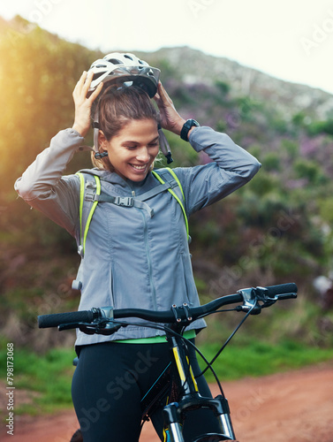 Helmet, woman and mountain bike in nature, fitness and cycling sports for adventure on path. Female person, athlete and bicycle for exercise in outdoors, cardio and training for off road competition