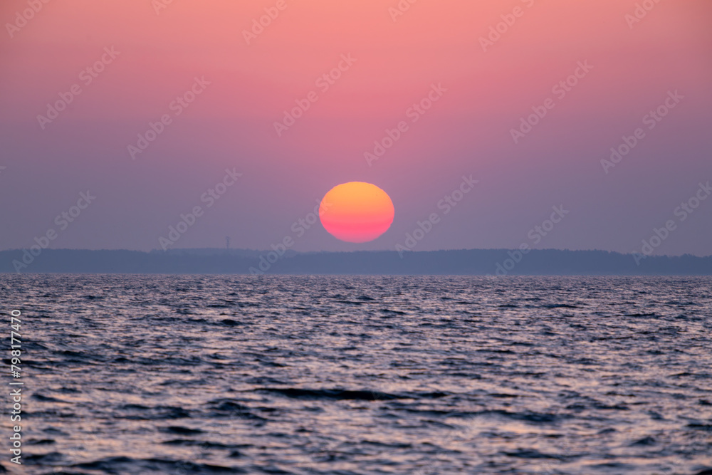 dawn over the sea, yellow-red sun close-up dawn over the sea, yellow-red sun close-up