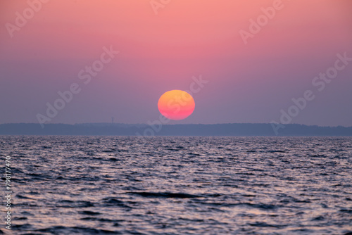 dawn over the sea, yellow-red sun close-up