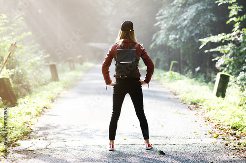 Woman in morning forest on the road