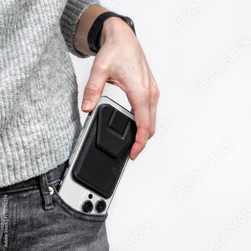 Woman taking out her phone from pocket