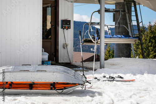medical sled on a downhill slope for tramping downhill skiers and snowboarders. Active and safe recreation photo