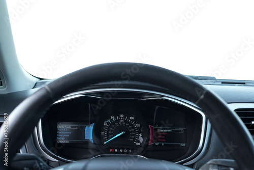 Speedometer on dashboard and steering wheel inside car © New Africa