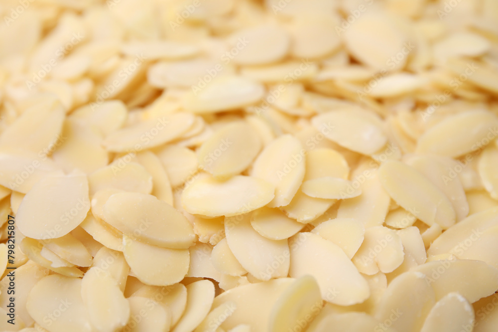 Fresh almond flakes as background, closeup view Fresh almond flakes as background, closeup view