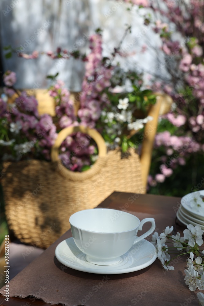 Beautiful spring flowers on table served for tea drinking in garden, closeup
